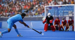 Harmanpreet Brace Powers India Past Wales 3-1 in World Cup Opener Indian field hockey player taking a penalty corner against Wales in an editorial illustration